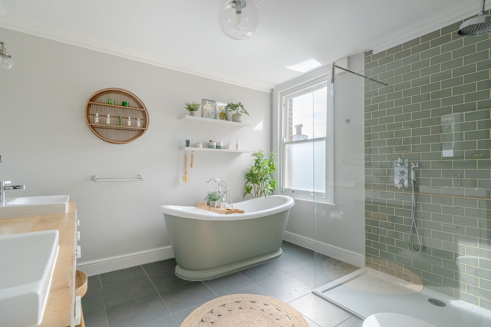 a bathroom photo from a property photography series, natural colours, bright and modern design space, light grey walls, showing the bathtub, the window and decorative elements on the wall