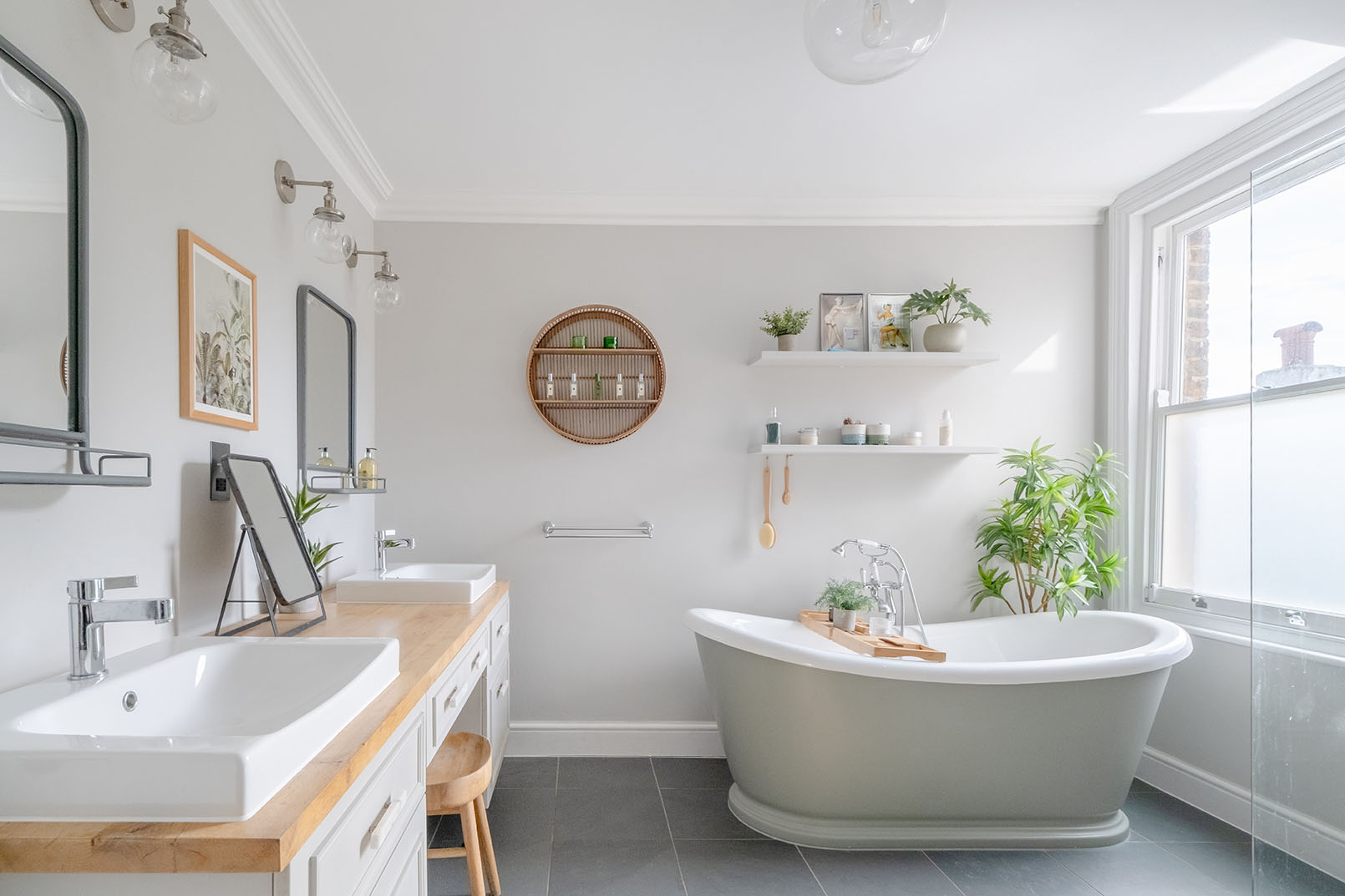 a bathroom photo from a property photography series, natural colours, bright and modern design space, light grey walls, showing the bathtub and partial counter with double sink