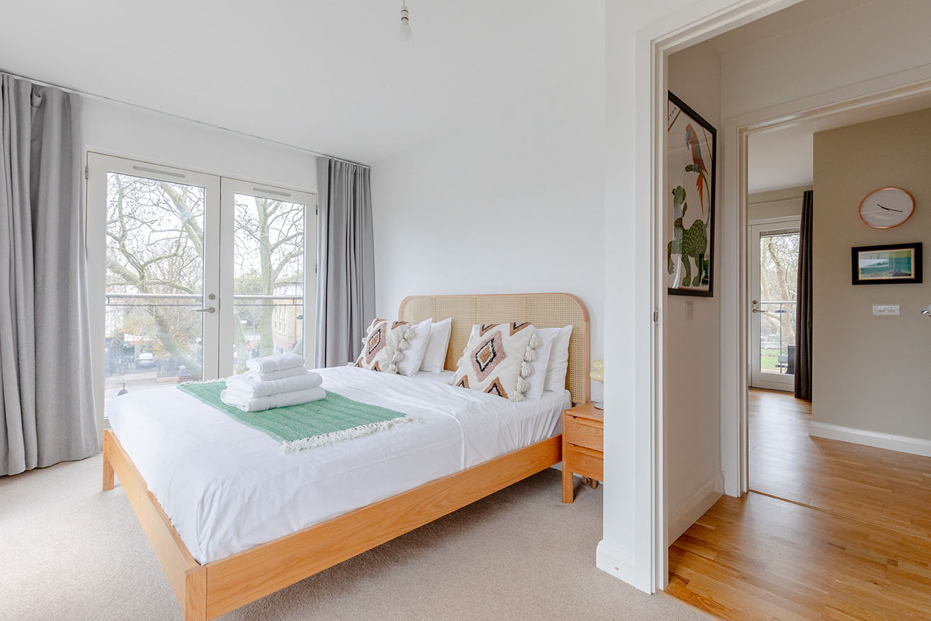 a bedroom photographed for property photography capturing the hall and the room at the end