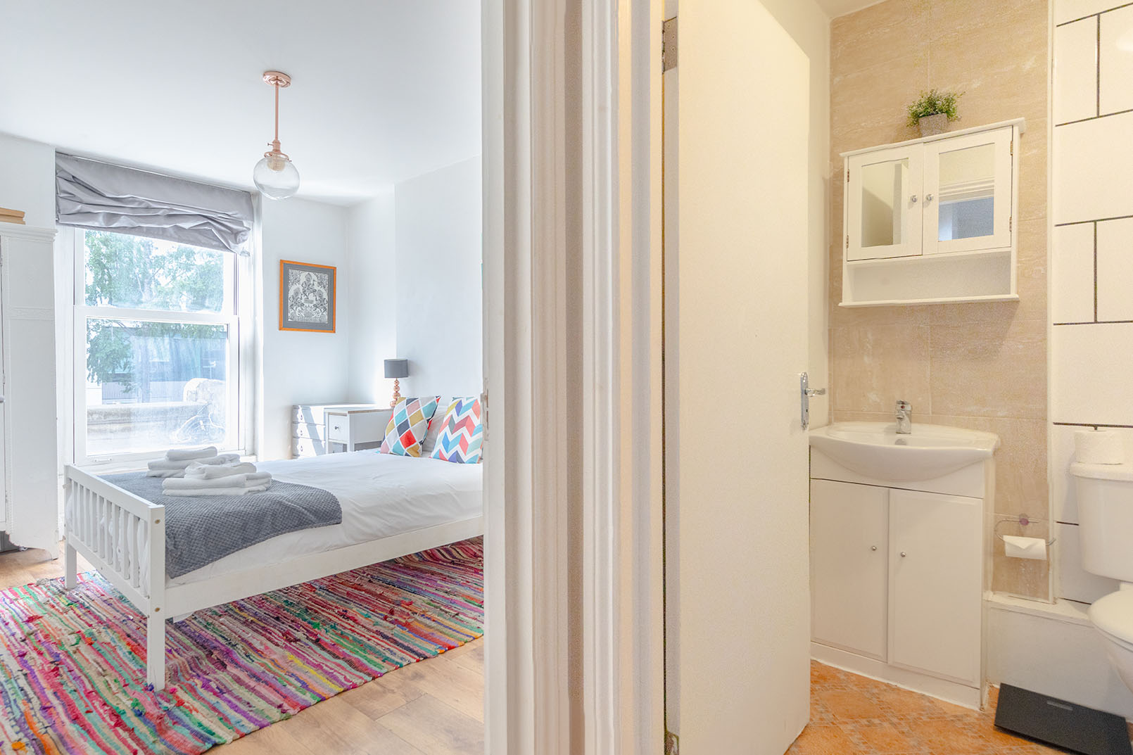 a combining property photography for a bedroom and showing its connection to the bathroom