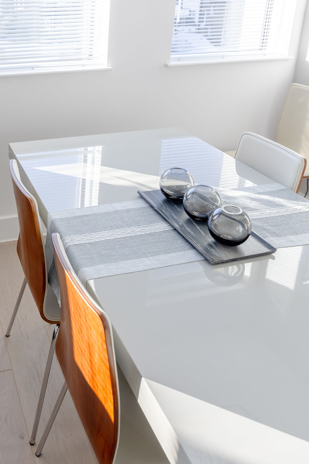 A white shiny dining table photographed for property photography for a short stay holiday airbnb listing