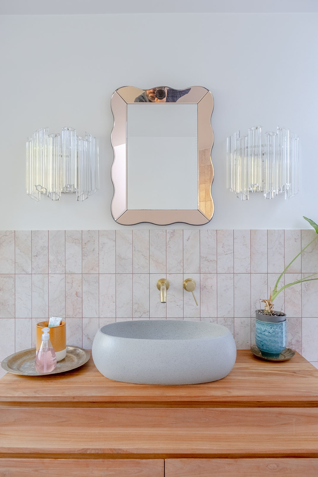 Bathroom detail image for property photography with a round grey sink and a shiny framed mirror