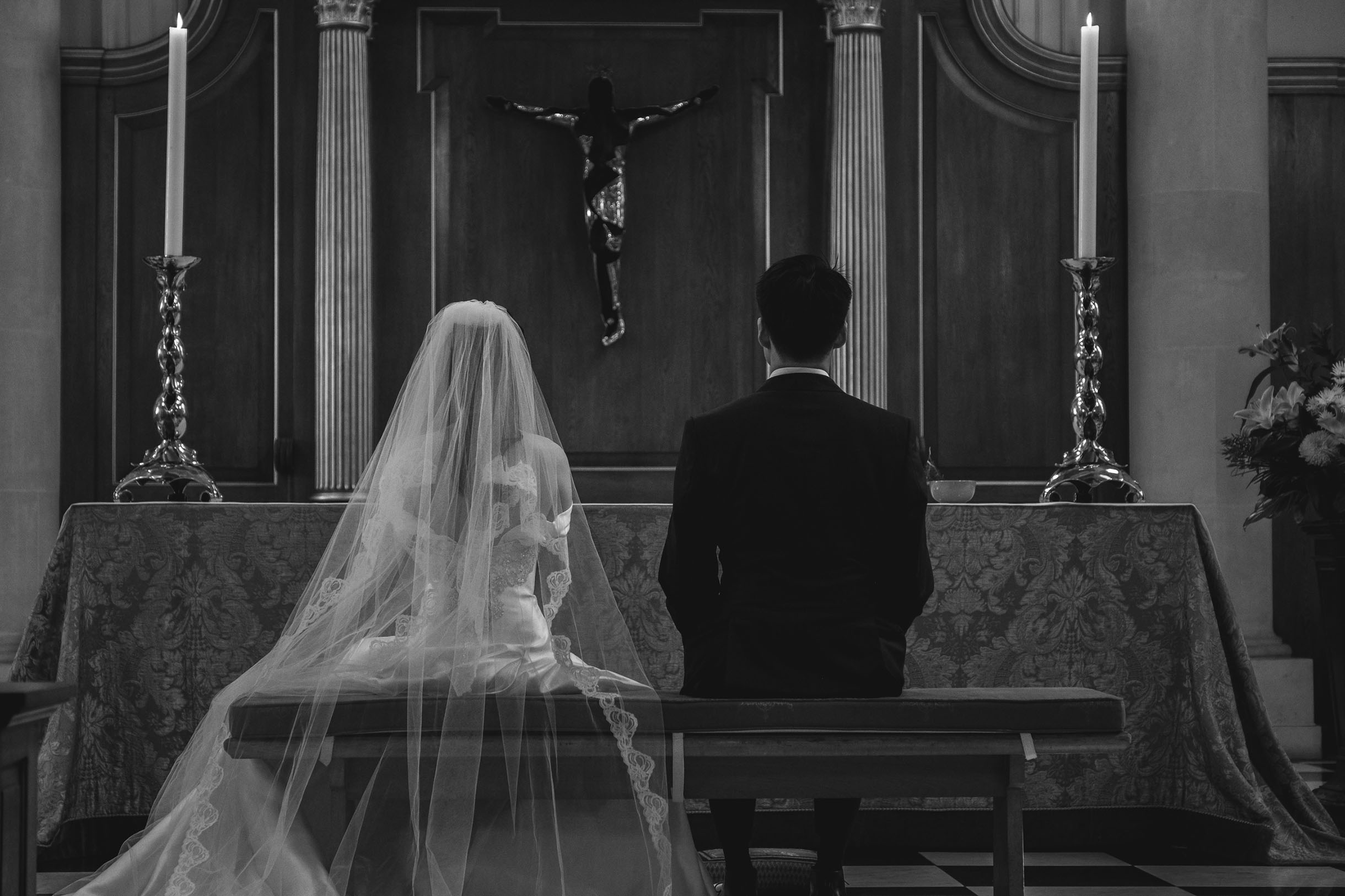 a couple from their back, inside the church, wedding ceremony captured by an experienced professional wedding photographer